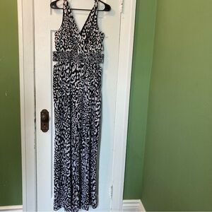 BEBE Black and White Leopard Print jumper suit with side cut outs and wide leg